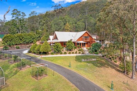 property featuring a two-story, four-bedroom house on roughly seven acres of land, perfect for those seeking a tranquil rural lifestyle and catering to equestrian enthusiasts,. . Rural properties for sale gold coast hinterland